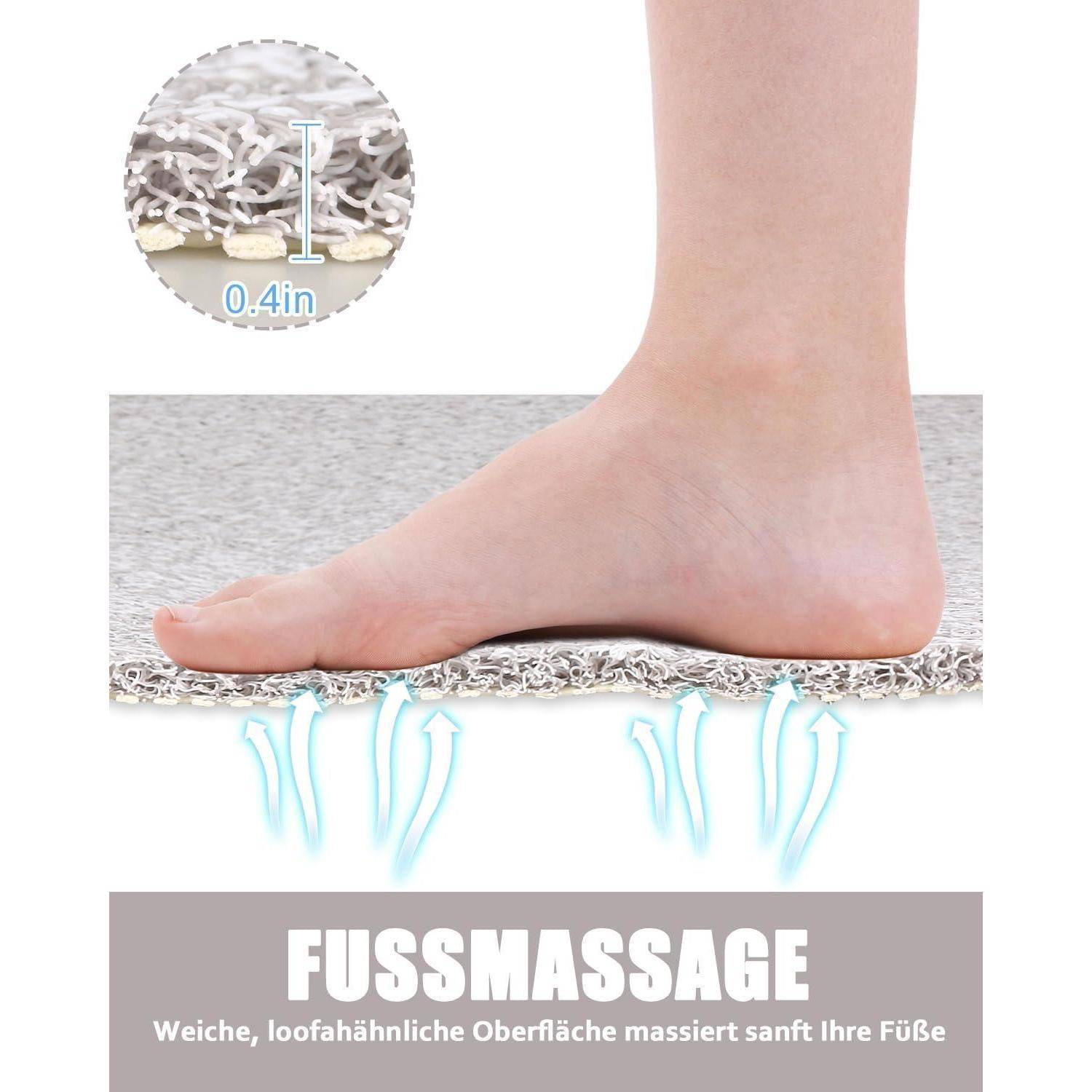 Fuß auf einer gepolsterten Matte mit der Bezeichnung „FUSSMASSAGE"; die Vergrößerung zeigt eine Dicke von 0,4 Zoll und deutschen Text, der eine weiche, fußmassierte Oberfläche beschreibt.