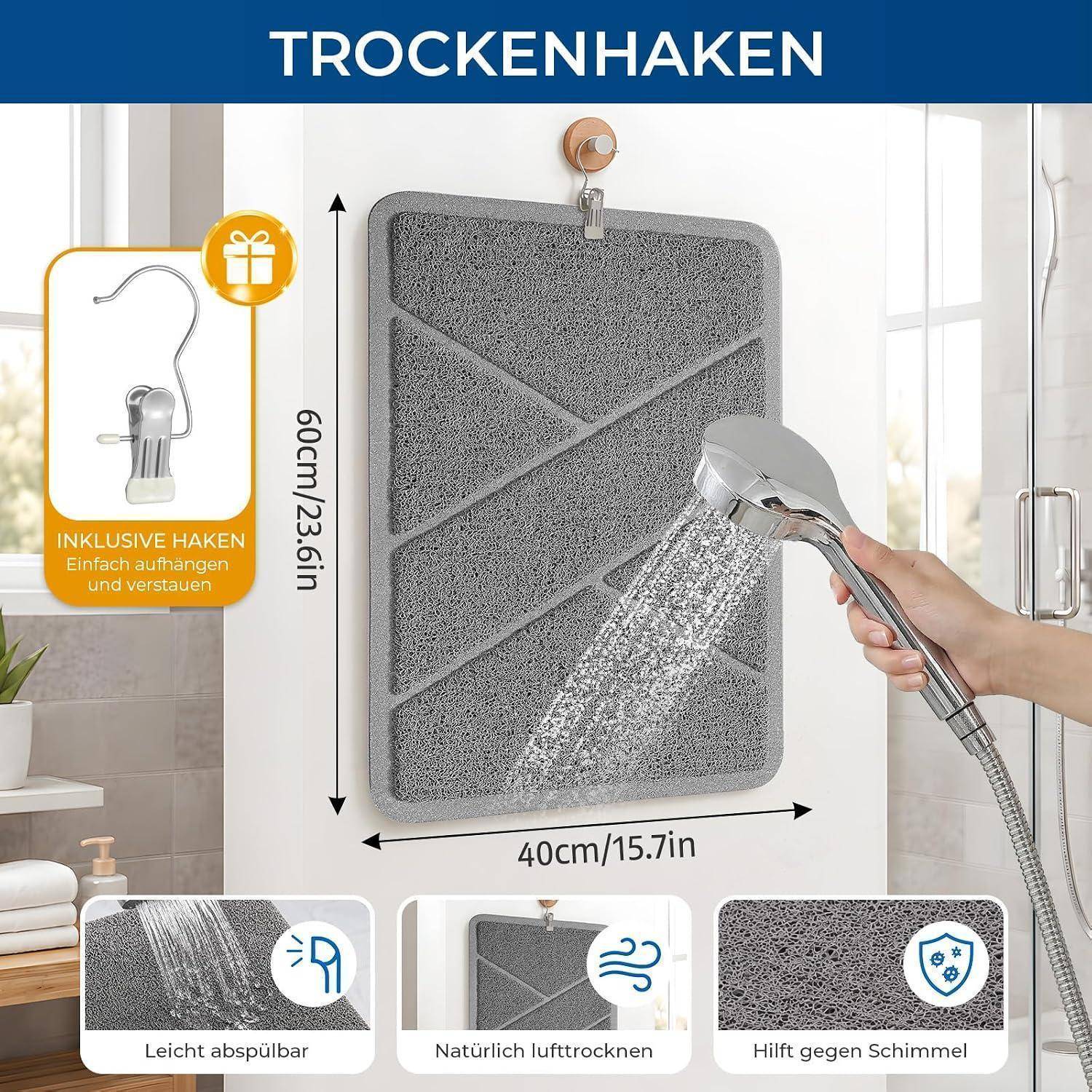 Graue hängende Badmatte wird beim Ausspülen gezeigt, mit Abmessungen von 60 cm x 40 cm und Symbolen für einfaches Aufhängen, schnelles Trocknen und Schimmelresistenz.