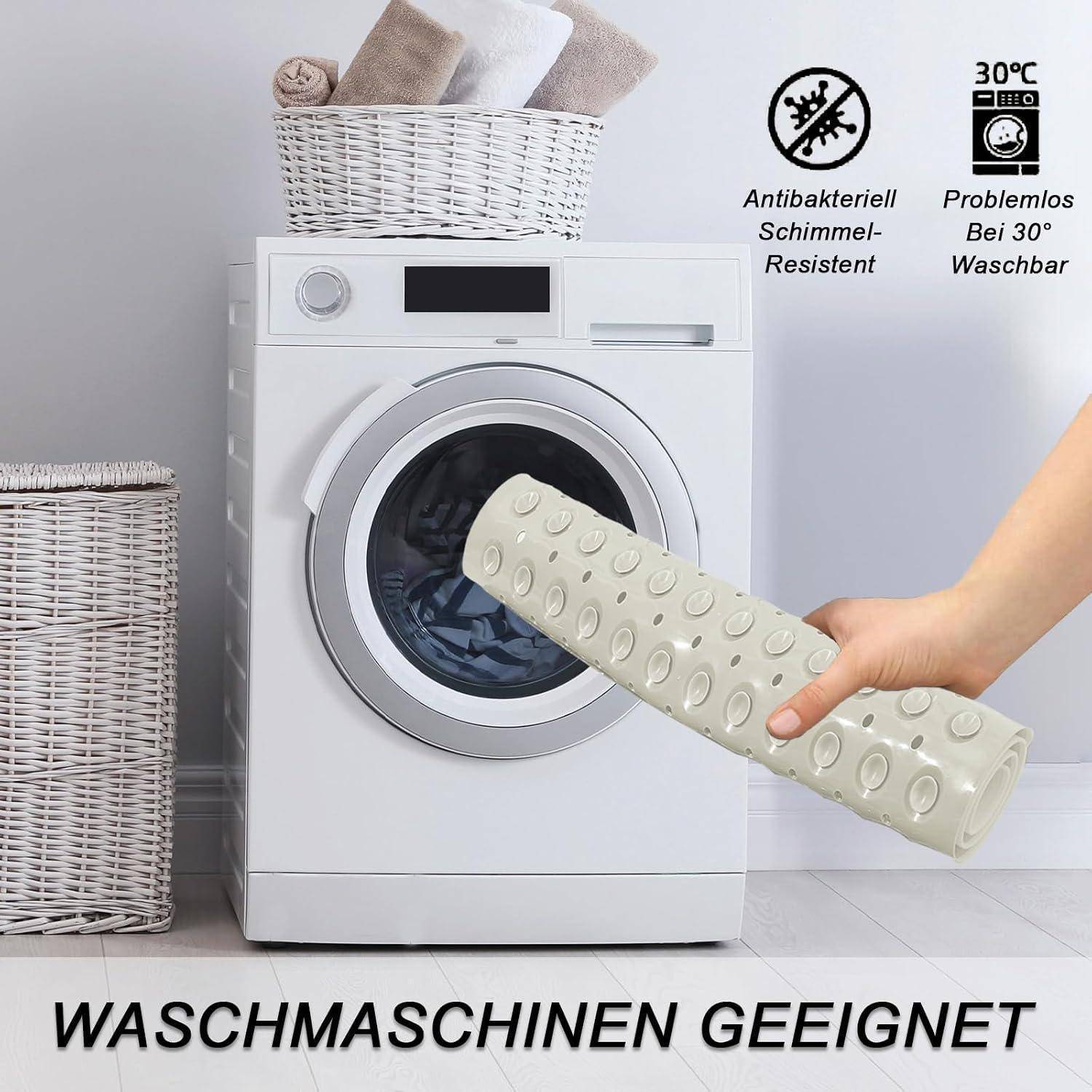 Produktbild einer strukturierten weißen Matte, die vor einer Waschmaschine gehalten wird, mit deutschem Text „WASCHMASCHINEN GEEIGNET