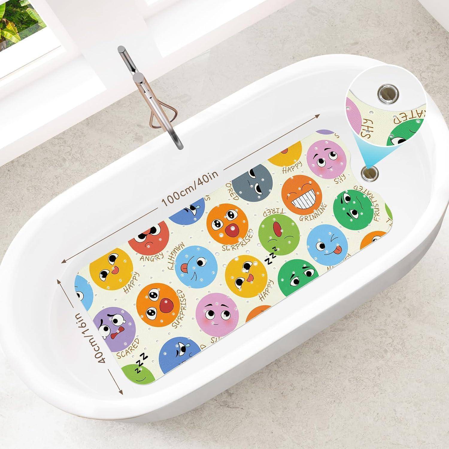 Weiße ovale Badewanne mit einer bunten rutschfesten Matte, auf der Cartoon-Emoji-Gesichter mit Emotionsbezeichnungen und Größenpfeilen „100 cm/40 Zoll" mal „40 cm/16 Zoll"" dargestellt sind.