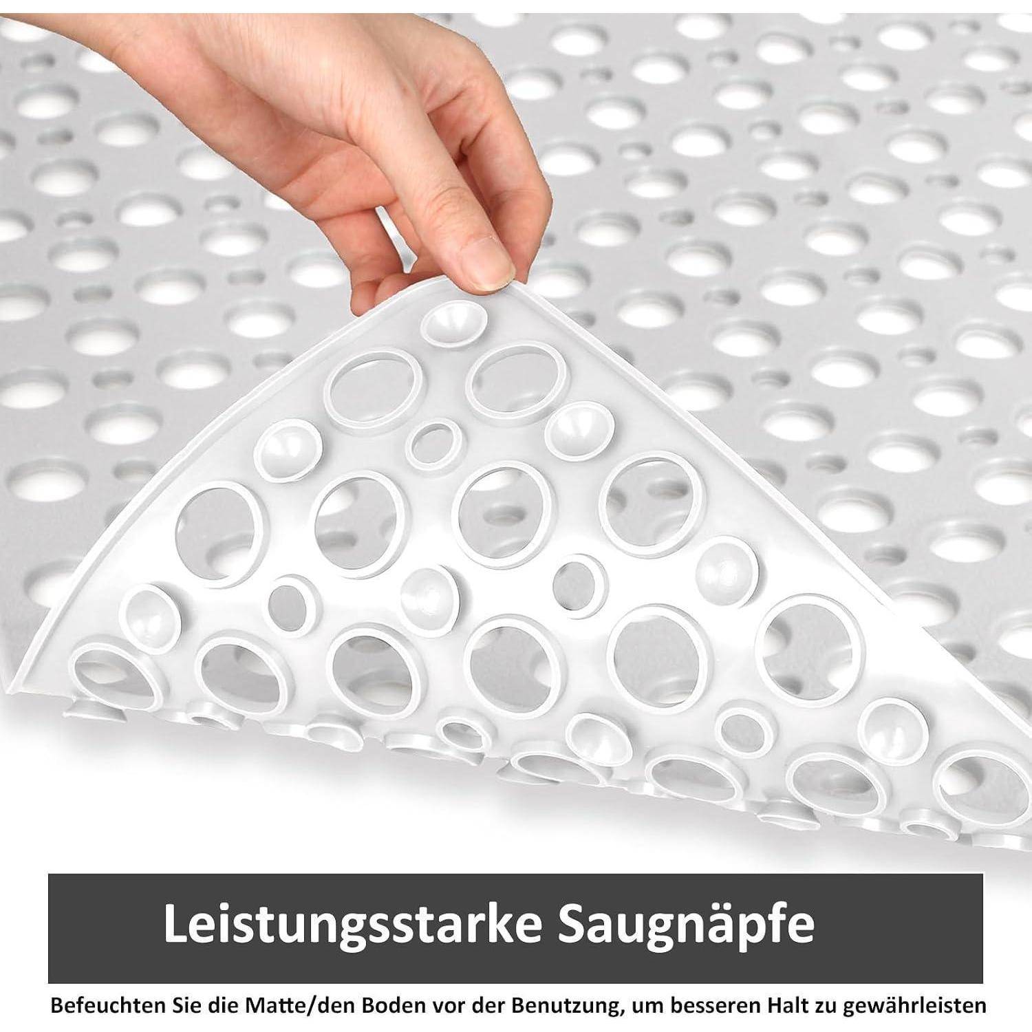 Eine Hand hält eine flexible weiße Matte mit Saugnäpfen; deutscher Text sagt „Leistungsstarke Saugnäpfe" und empfiehlt, die Matte/den Boden zu befeuchten, um eine bessere Bodenhaftung zu erreichen.