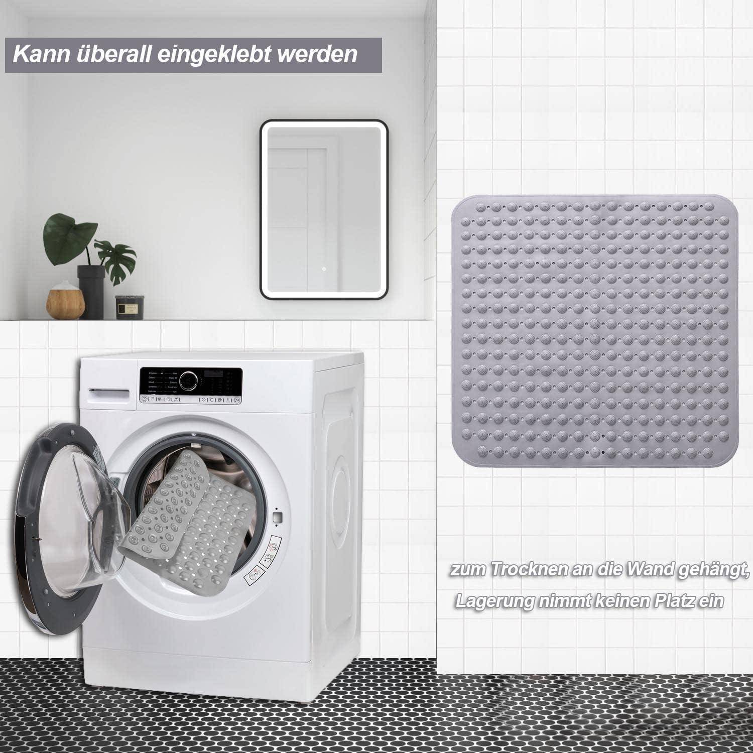 Eine Wäscheraum-Anzeige zeigt eine Waschmaschine mit einer abnehmbaren grauen Matte, die an jede Wand geklebt werden kann, um sie ohne Platzverschwendung zu trocknen und zu lagern.
