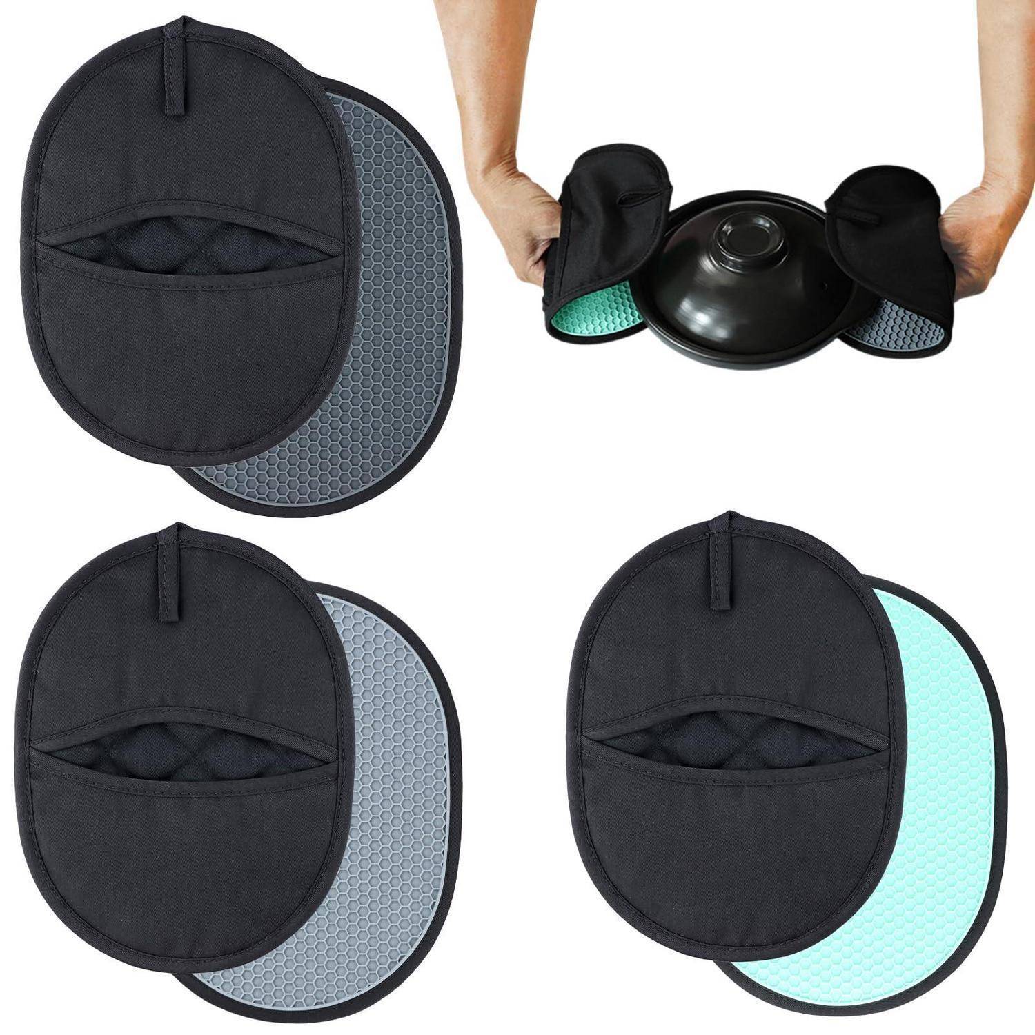 Ovale schwarze Stoffwärmepads und Silikon-Wärmepads in verschiedenen Farben, wobei eines über eine runde schwarze Schüssel oder ein Behältnis gelegt wird.