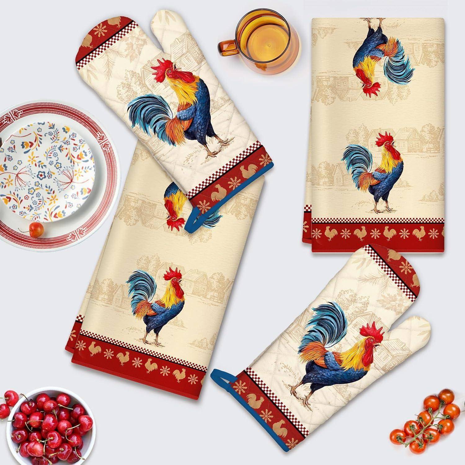 Satz von Hahn-Design Küchentextilien, bestehend aus Ofenhandschuhen, Handtüchern und Topflappen in Creme, Rot und Blau auf hellem Hintergrund.