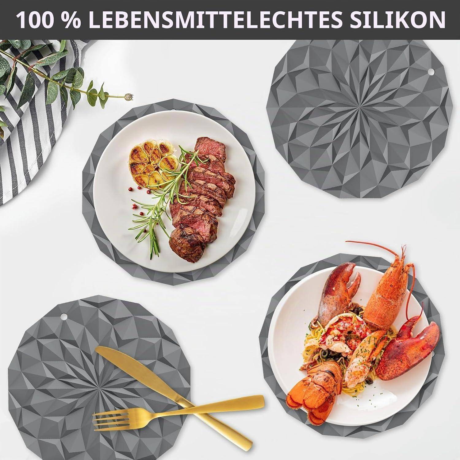 Werbebild von grauen facettierten Silikon-Tischsets unter Tellern mit Steak und Hummer, beschriftet mit „100 % LEBENSMITTELECHTES SILIKON