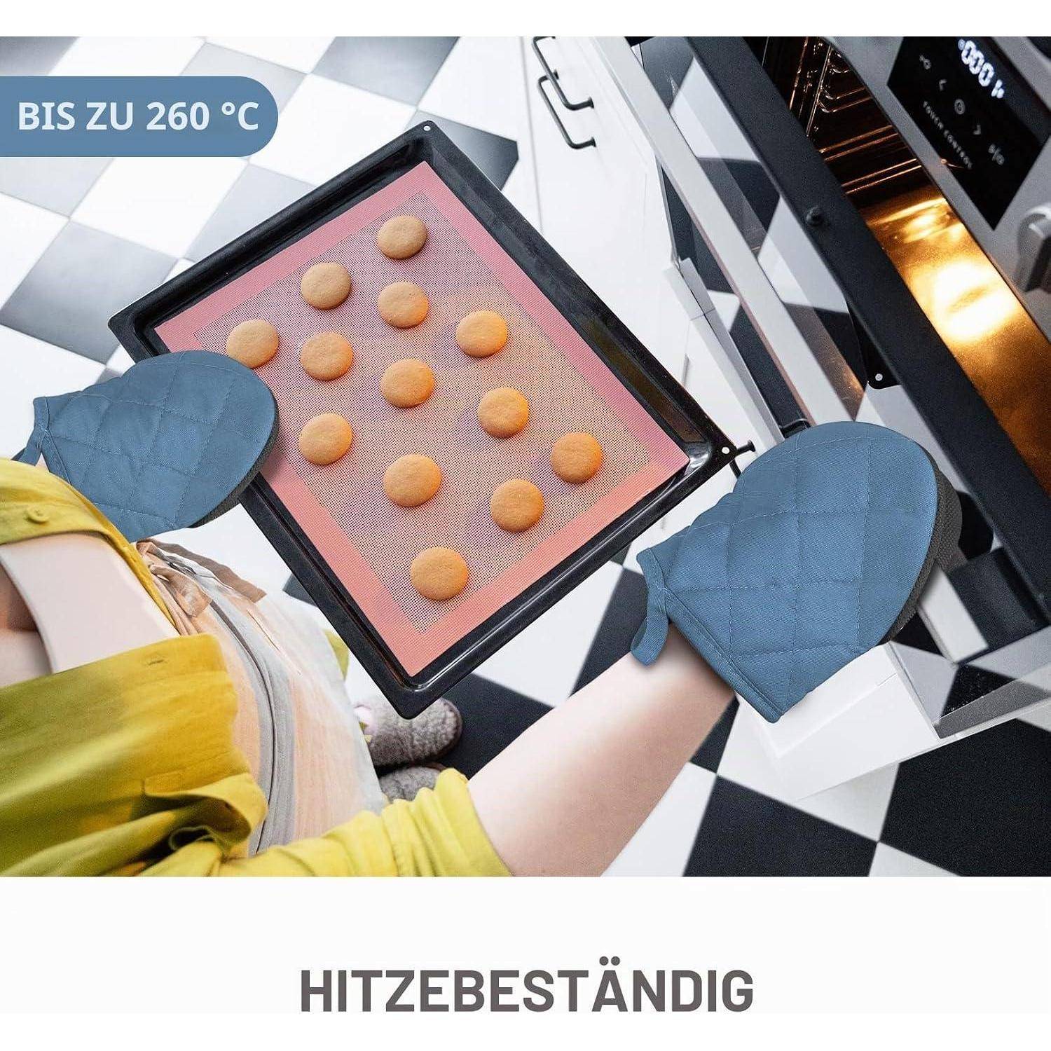 Ofenhandschuh mit Keksen in einem Tablett und Ofenhandschuhen; Text sagt „BIS ZU 260 °C