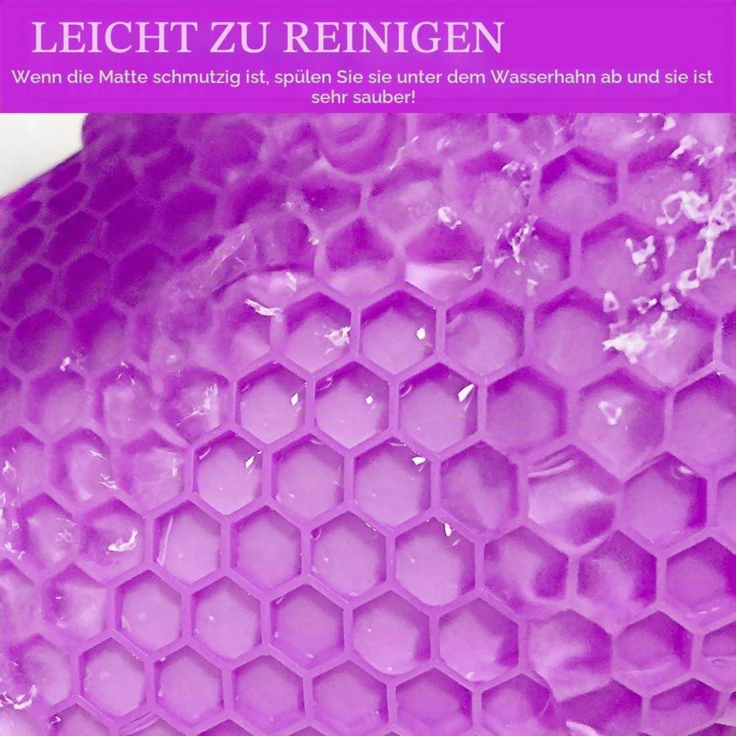 Violette sechseckige Matte wird unter fließendem Wasser gespült, mit deutschem Text, der besagt, dass sie leicht zu reinigen ist und unter Wasser sehr sauber wird.