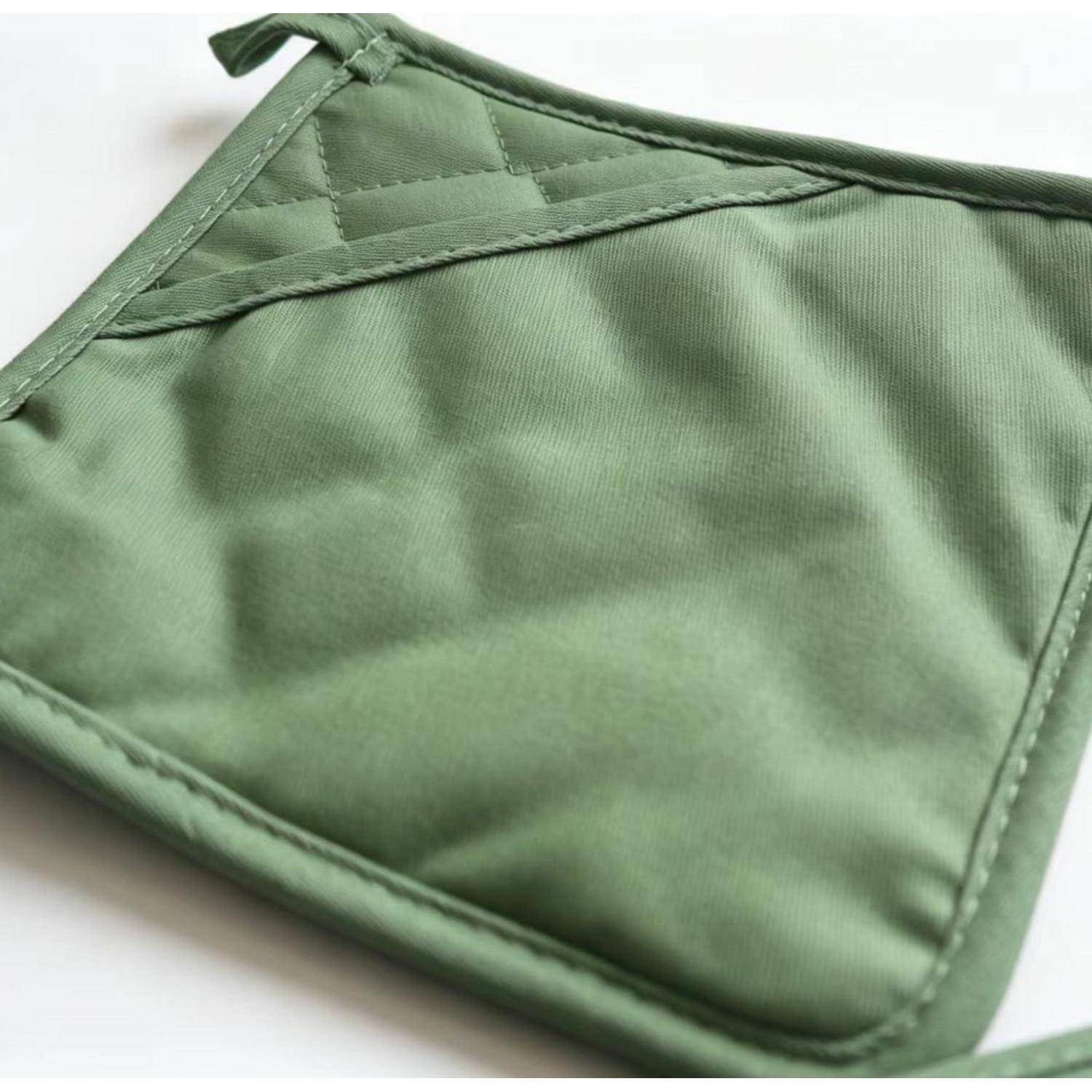 Grüne gesteppte Ofenhandschuh oder Topflappen mit einer Aufhängeschleife auf weißem Hintergrund.