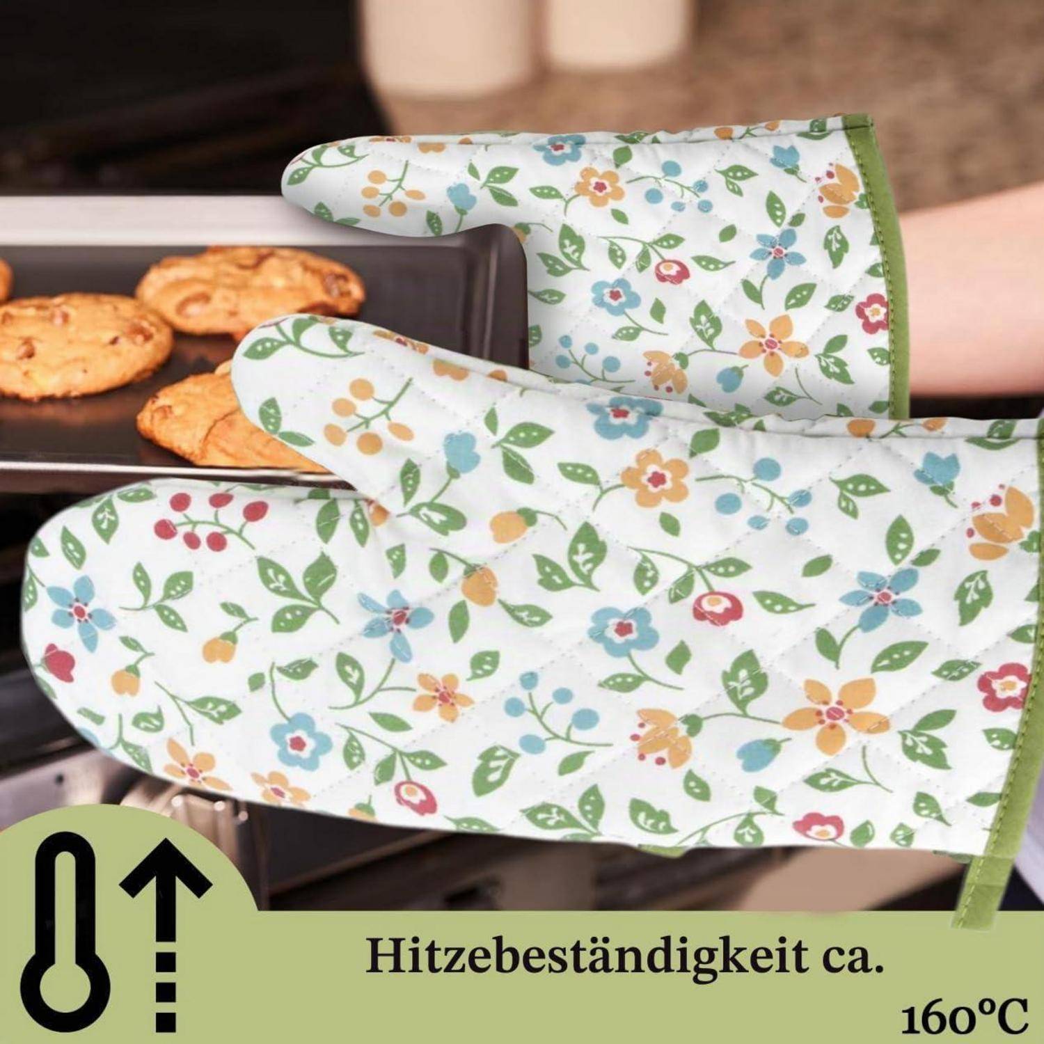 Blumige Ofenhandschuhe halten ein Backblech mit Keksen; deutscher Text sagt „Hitzebeständigkeit ca. 160°C