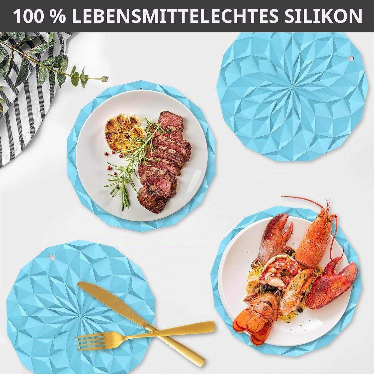 Werbebild von türkisfarbenen Silikonuntersetzer und Unterlagen unter Tellern mit Steak und Hummer, mit deutschem Text „100 % LEBENSMITTELECHTES SILIKON