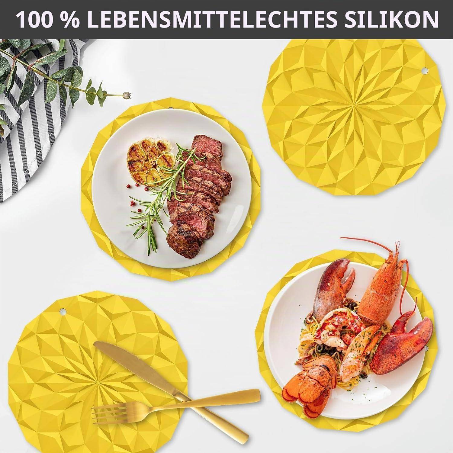 Werbung für zu 100% lebensmittelecho Silikonunterlagen und Untersetzer in leuchtendem Gelb, gezeigt unter Tellern mit Steak und Hummer auf einem weißen Tisch.