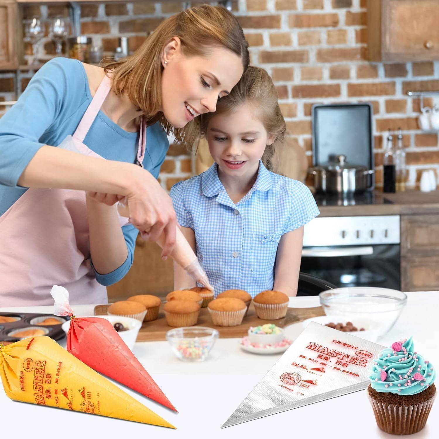 Frau und junges Mädchen dekorieren gemeinsam Cupcakes in einer Küche, mit Spritzbeuteln, Zuckerguss und Streuseln auf der Arbeitsplatte.