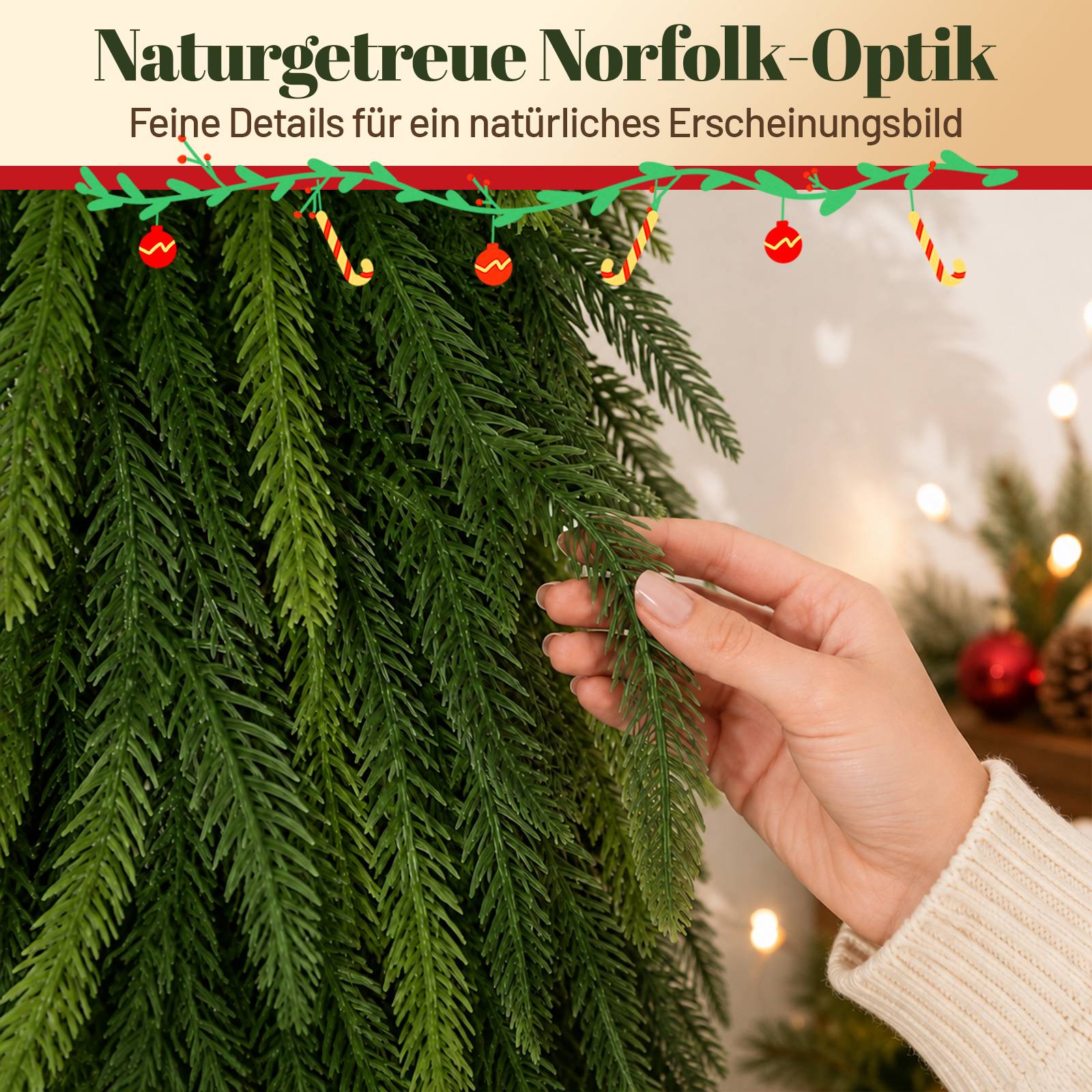Nahaufnahme einer Hand, die dichte künstliche Immergrünzweige berührt, wirbt für 'Naturgetreue Norfolk-Optik' und einen natürlichen Look.