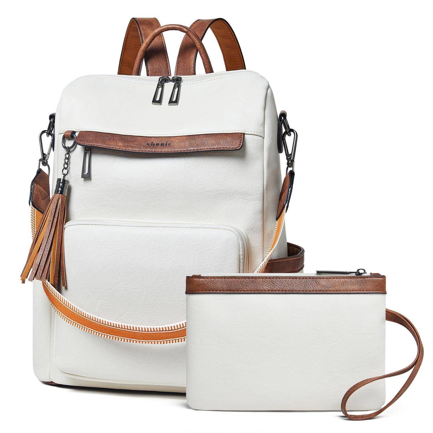 Weißer Rucksack und passende kleine Tasche mit braunen Lederakzenten, Reißverschlüssen, Quastenanhänger und Schultergurten auf neutralem Hintergrund.
