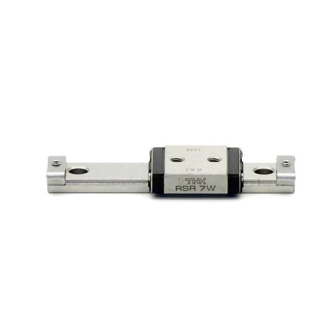 Ein lineares Schienenlagerblock auf einer Metallführungsschiene, mit Montagelöchern und Kennzeichnung „THK RSR 7W