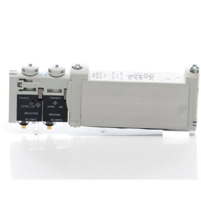 Nahaufnahme eines grauen elektrischen Relais oder Schützermoduls mit zwei schwarzen Spuleneinheiten auf der linken Seite und einem großen rechteckigen Gehäuse auf der rechten Seite.