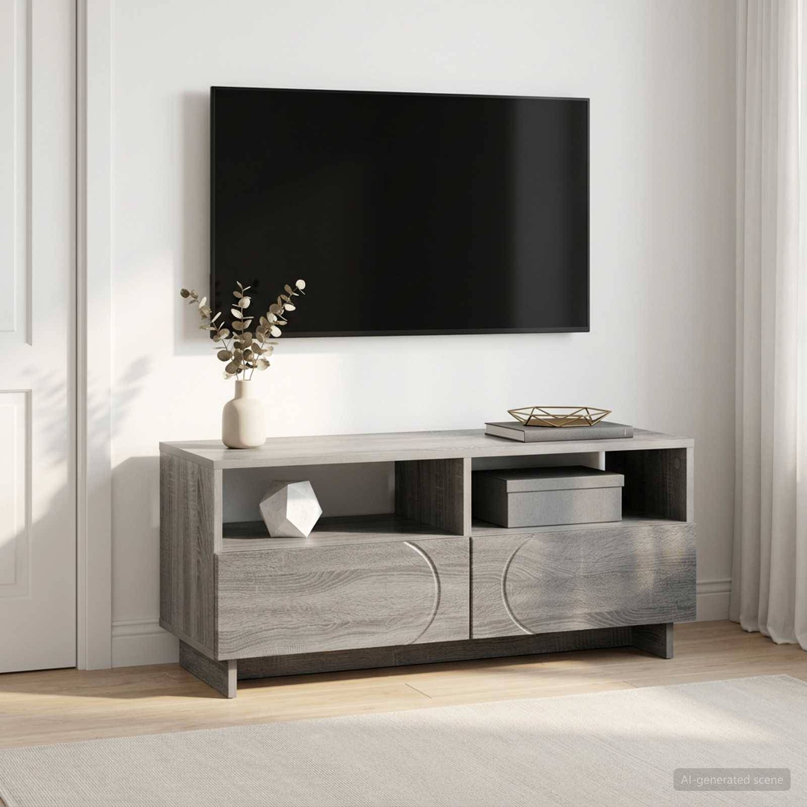 An der Wand montierter schwarzer Fernseher über einer grauen Holzmedienkommode mit Dekoration an einer hellen, minimalistischen Wohnzimmerwand.