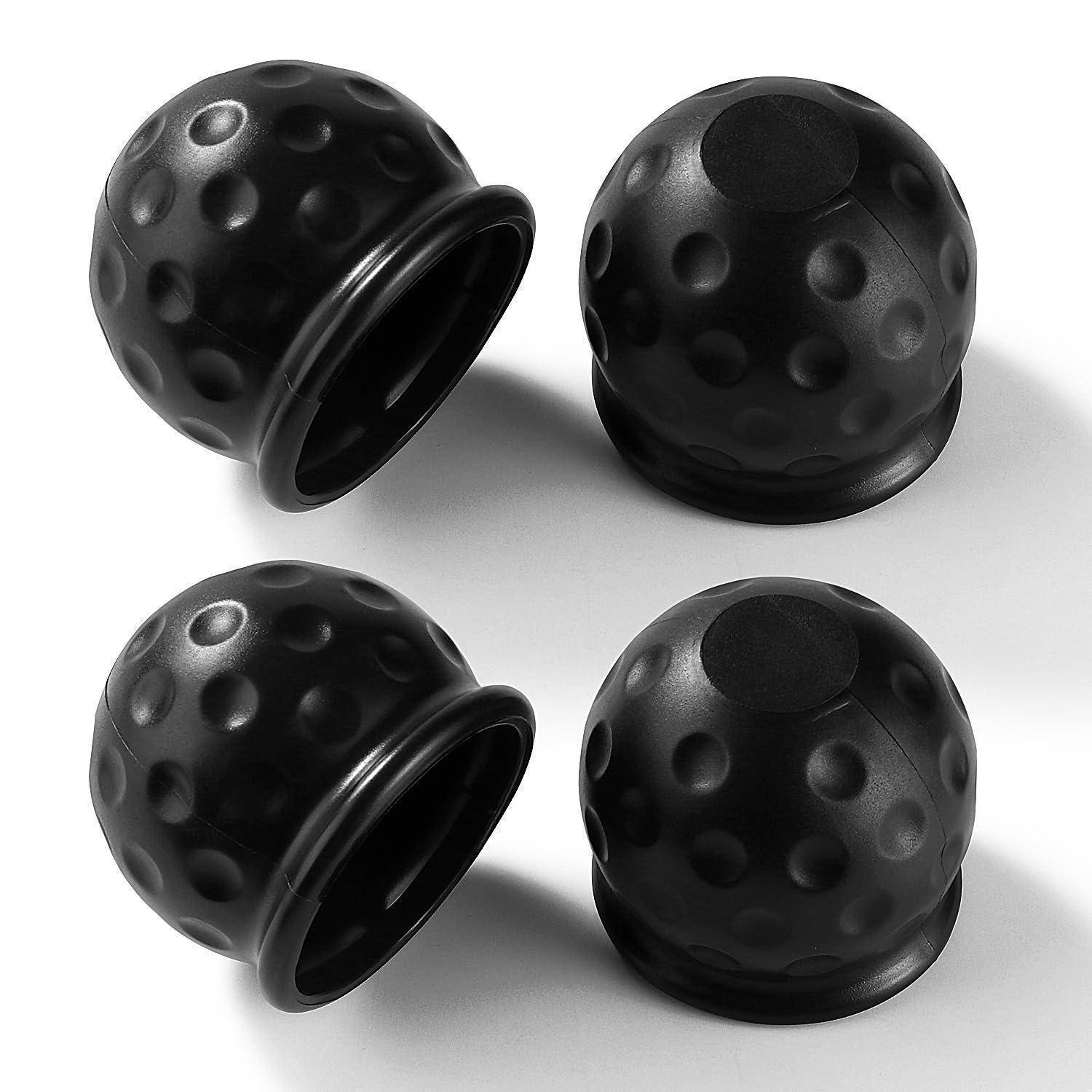 Vier schwarze, mit Dellen versehene, golfballförmige Kappen oder Abdeckungen, gezeigt aus zwei Blickwinkeln auf weißem Hintergrund.