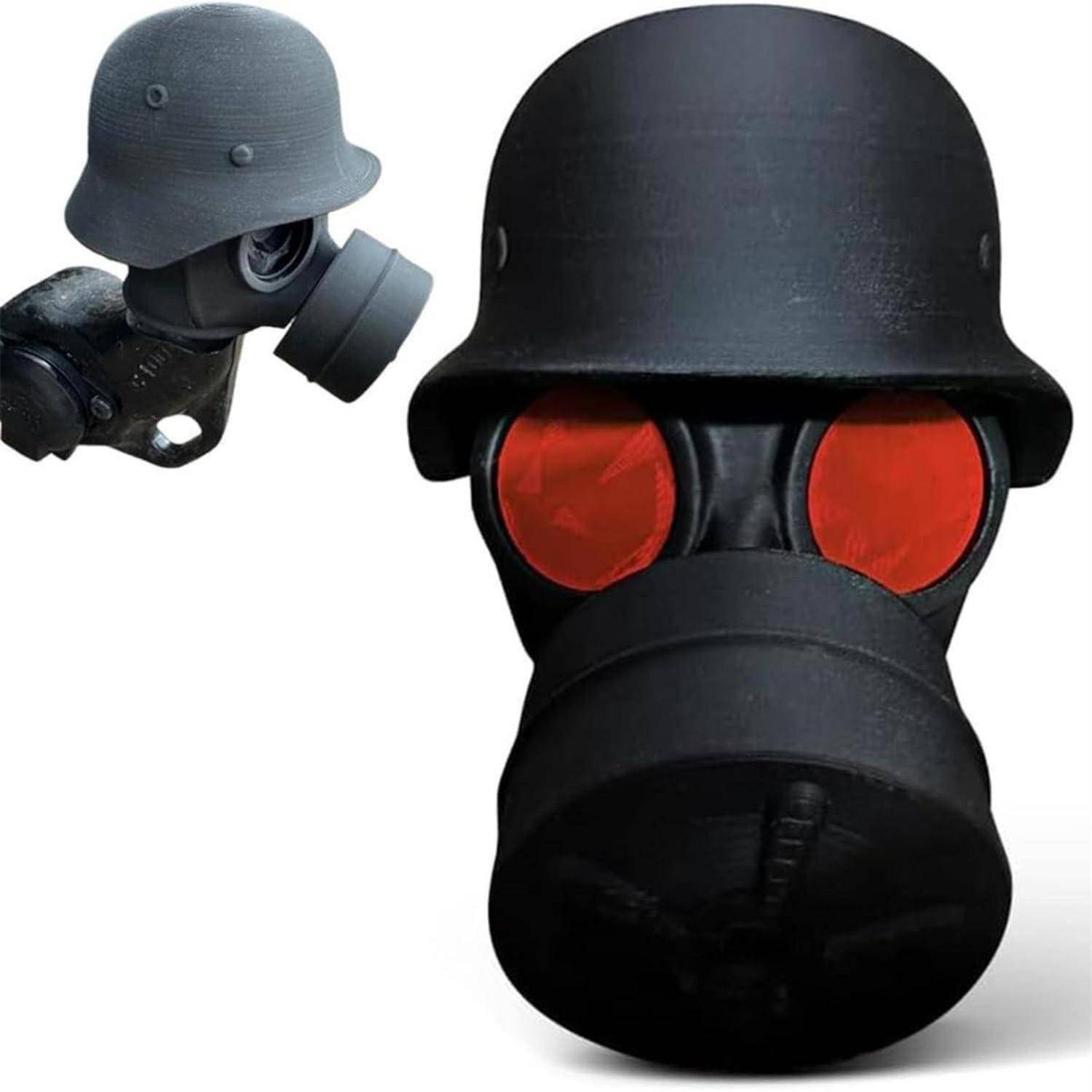 Schwarze Militär-Gasmaske mit helmartiger Kappe und roten Augengläsern, dargestellt in Seiten- und Vorderansicht auf weißem Hintergrund.