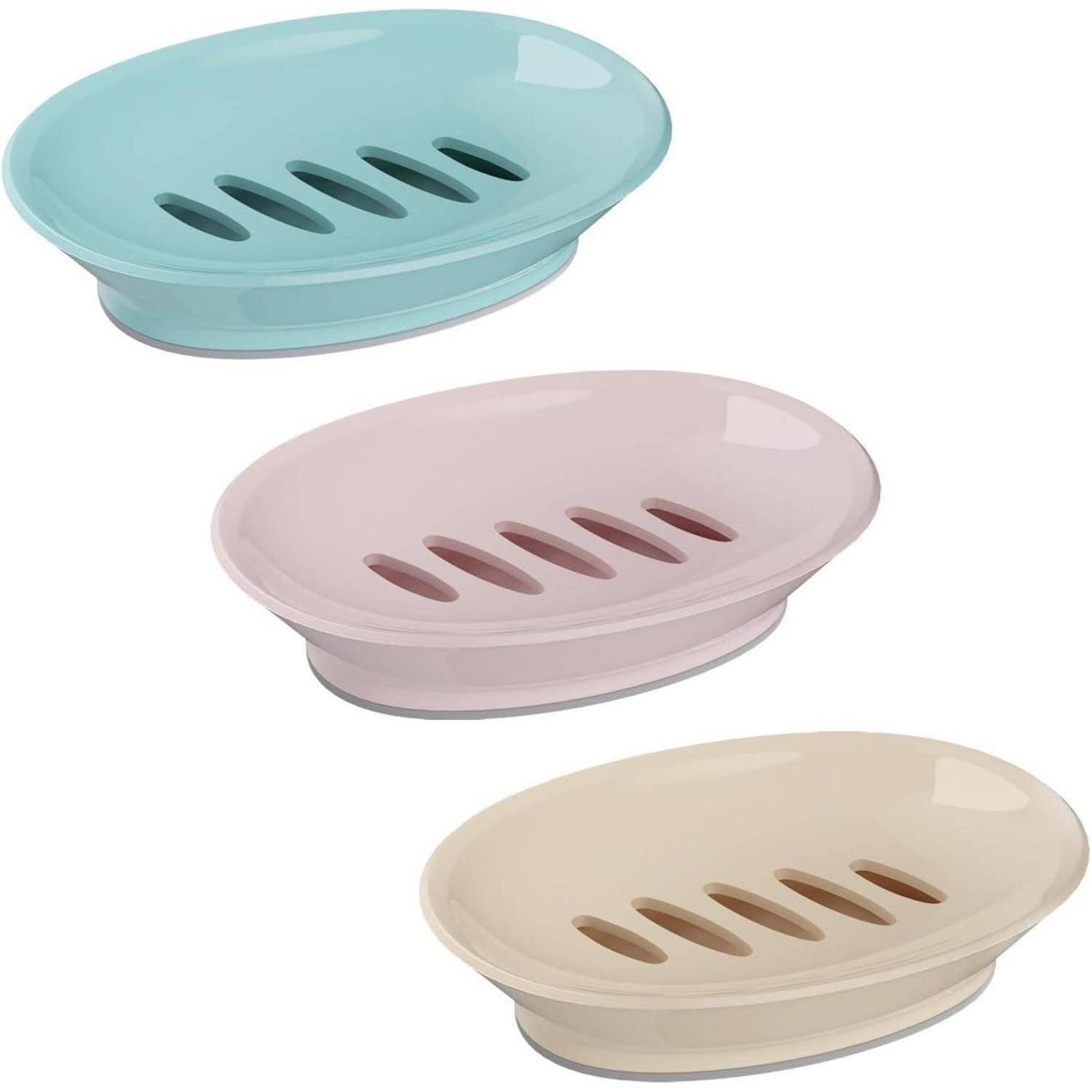 Drei ovale Seifenschalen in Aqua, Rosa und Beige, jede mit Entwässerungslöchern und erhöhter Basis.