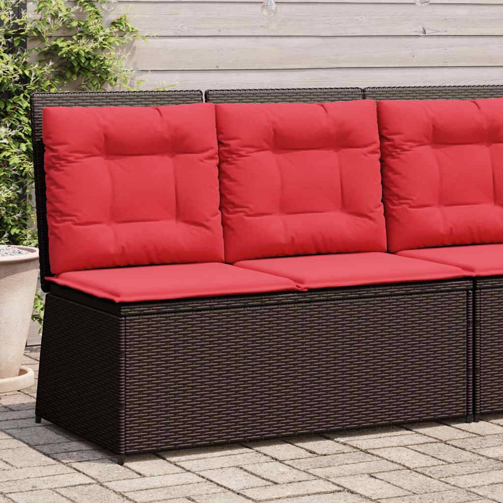 Outdoor-Korbsofa mit roten Kissen auf einer Terrasse an einer Hauswand.
