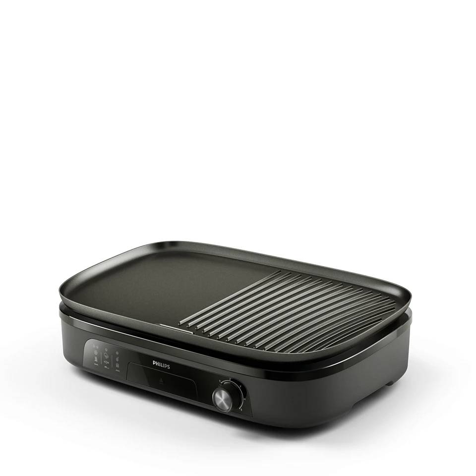 Schwarze Philips Elektrogrill mit ebener Kochfläche und gerilltem Grillbereich, gezeigt in einer Studio-Produktaufnahme.