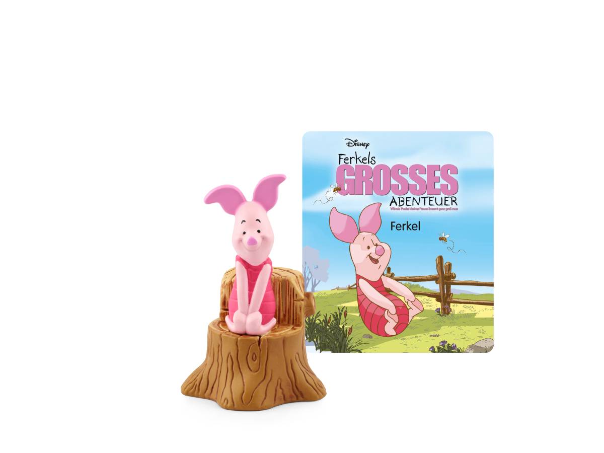 Ferkelfigurine auf einem Baumstumpf vor einem Disney-Cover „Ferkels Großes Abenteuer