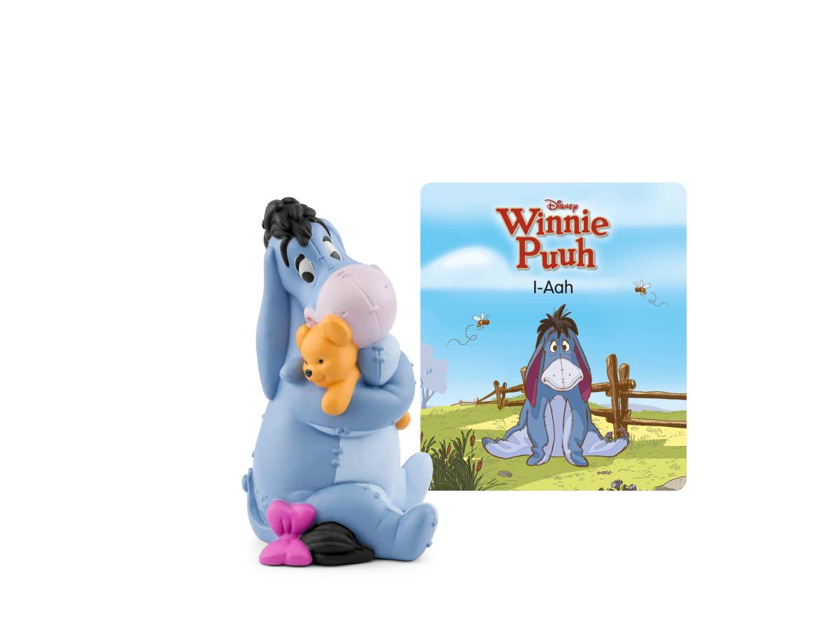 Eeyore-Figur, die Winnie Puuh umarmt, gezeigt neben einem Coverbild von „Disney Winnie Puuh: I-Aah