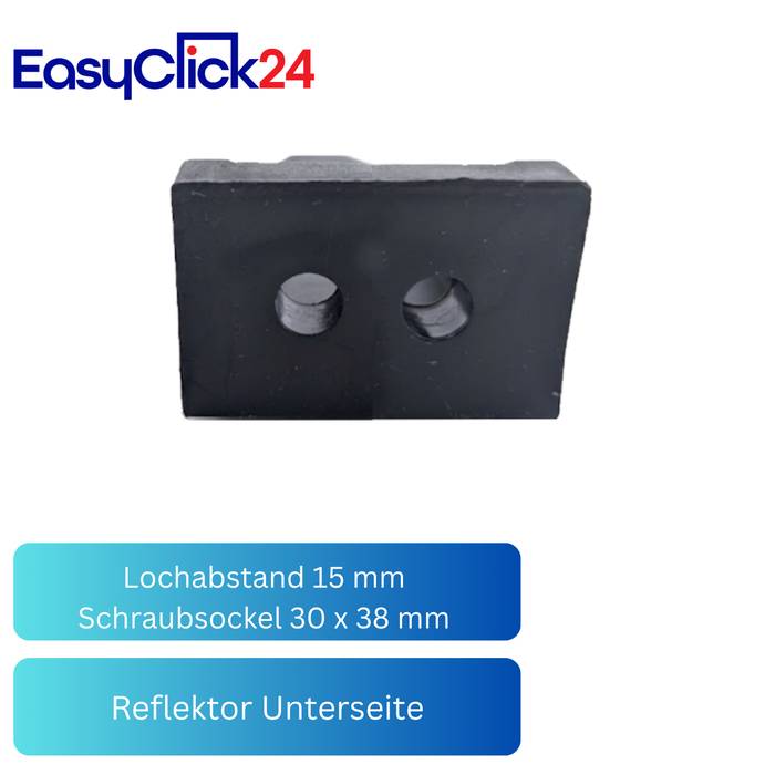 Schwarzer rechteckiger Gummiblock mit zwei runden Löchern, beschriftet mit „Lochabstand 15 mm", „Schraubsockel 30 x 38 mm"" und „Reflektor Unterseite"" unter dem EasyClick24-Logo.