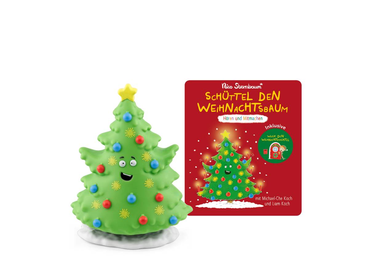 Ein grünes weihnachtsbaumförmiges Spielzeug mit bunten Verzierungen und einem lächelnden Gesicht sitzt neben der roten Schachtel mit der Aufschrift „Schüttel den Weihnachtsbaum