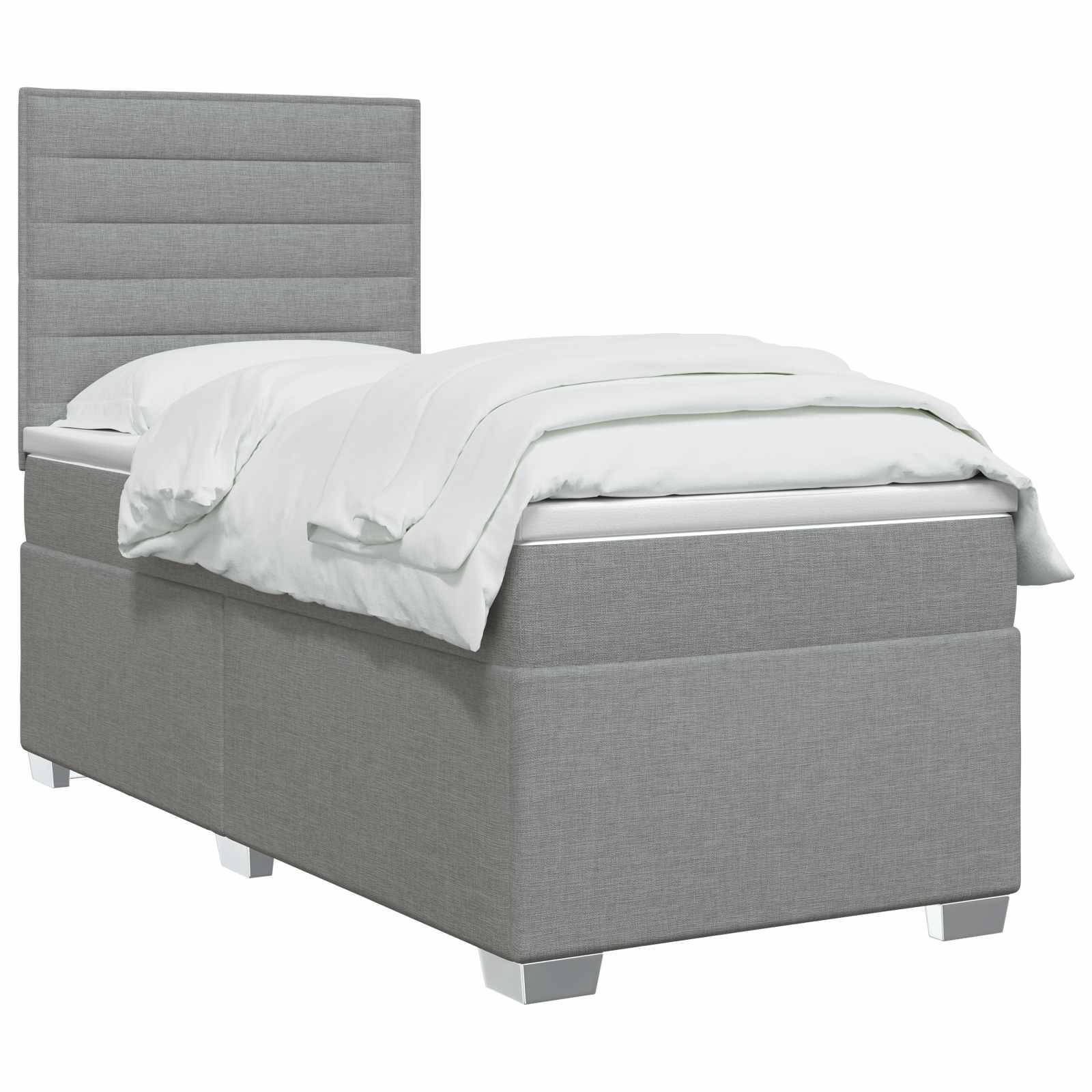 Grau gepolstertes Einzelbett mit hohem gepolstertem Kopfteil, weiße Bettwäsche und Speicher-Stil-Basis auf weißem Hintergrund.