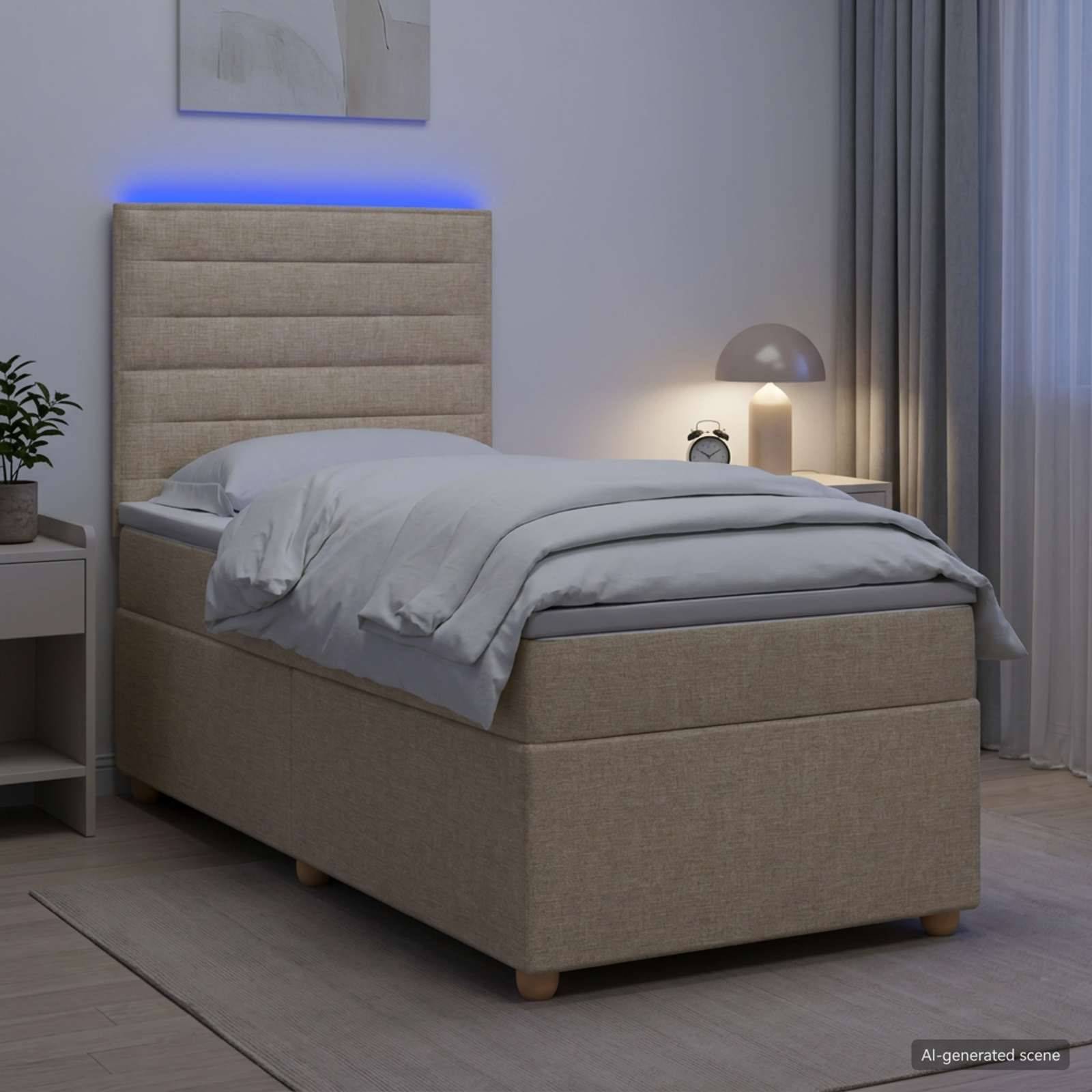 Modernes beiges gepolstertes Einzelbett mit blauem Kopfteil und Hintergrundbeleuchtung in einem sanft beleuchteten Schlafzimmer neben einem Nachttisch und einer Lampe.