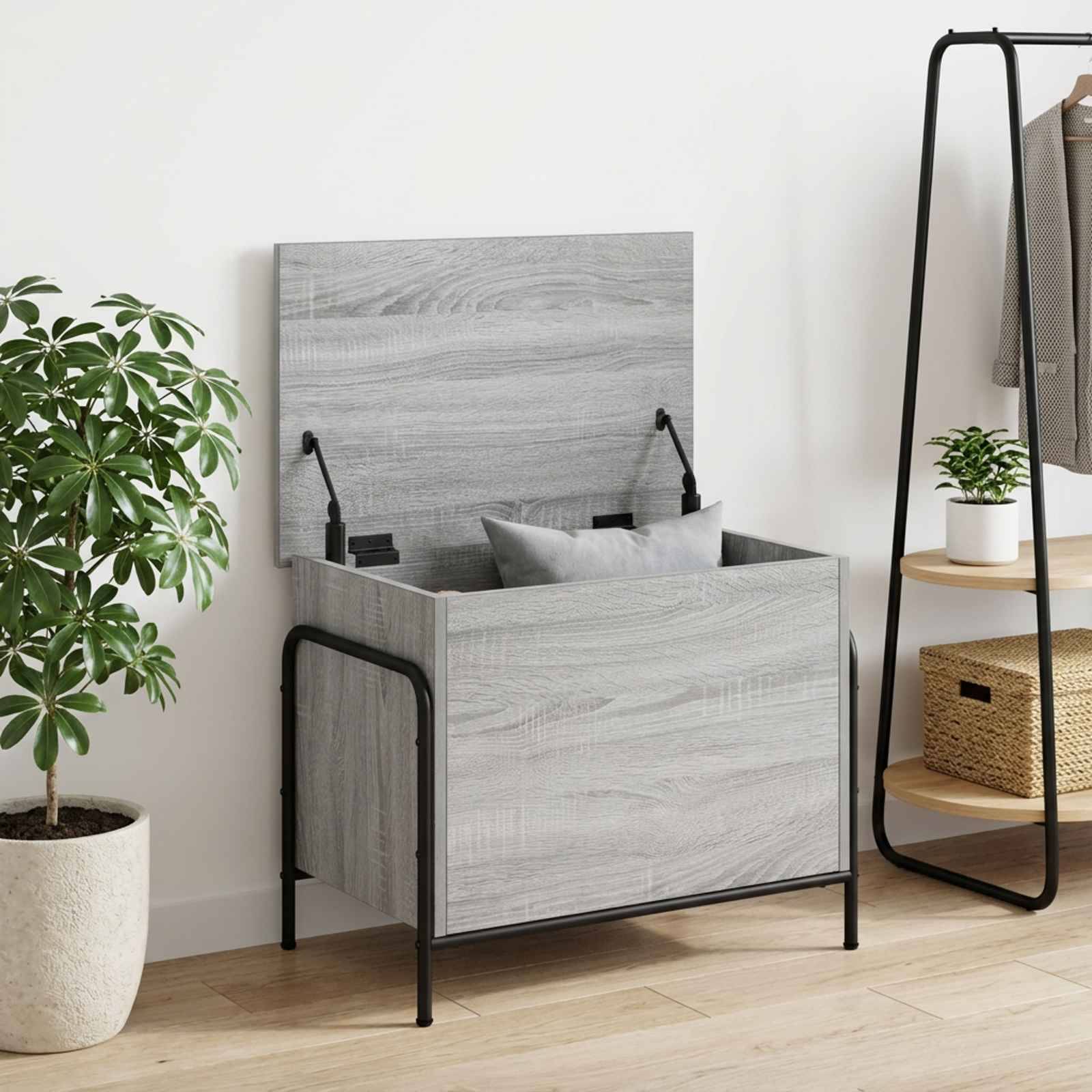 Grauholz-Stauraumbett mit klappbarem Kopfteil, das sich öffnet und Kissen freilegt, gezeigt in einem modernen Zimmer mit einer Pflanze und einem Kleiderständer.