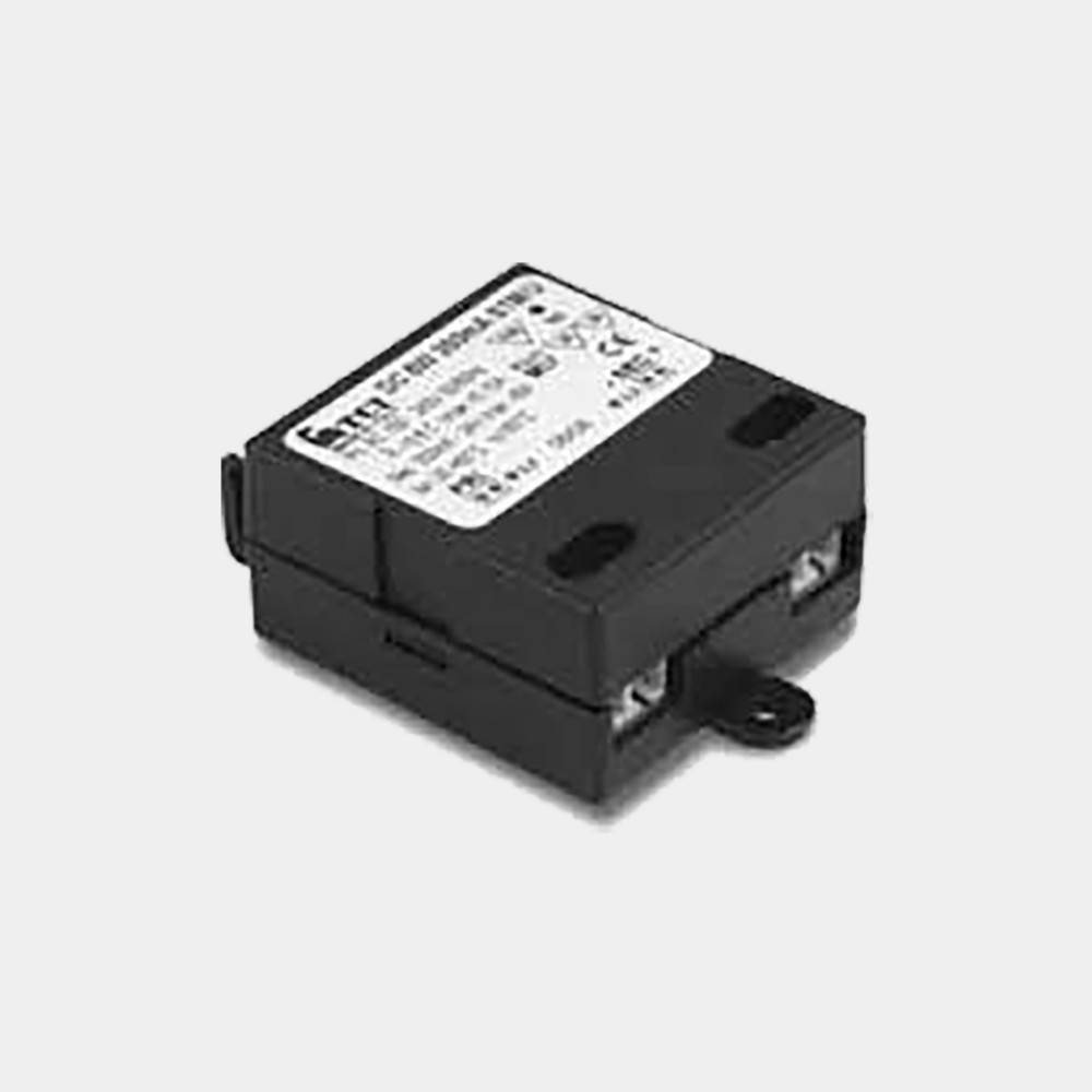 Schwarzes Elektroschutzschaltermodul mit weißem Etikett und seitlicher Befestigungslasche auf einfachem Hintergrund.