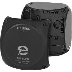 Schwarze Hensel-Elektroverteilerdose mit abgenommener Frontabdeckung, die die inneren Befestigungslöcher und den Verdrahtungsraum zeigt.