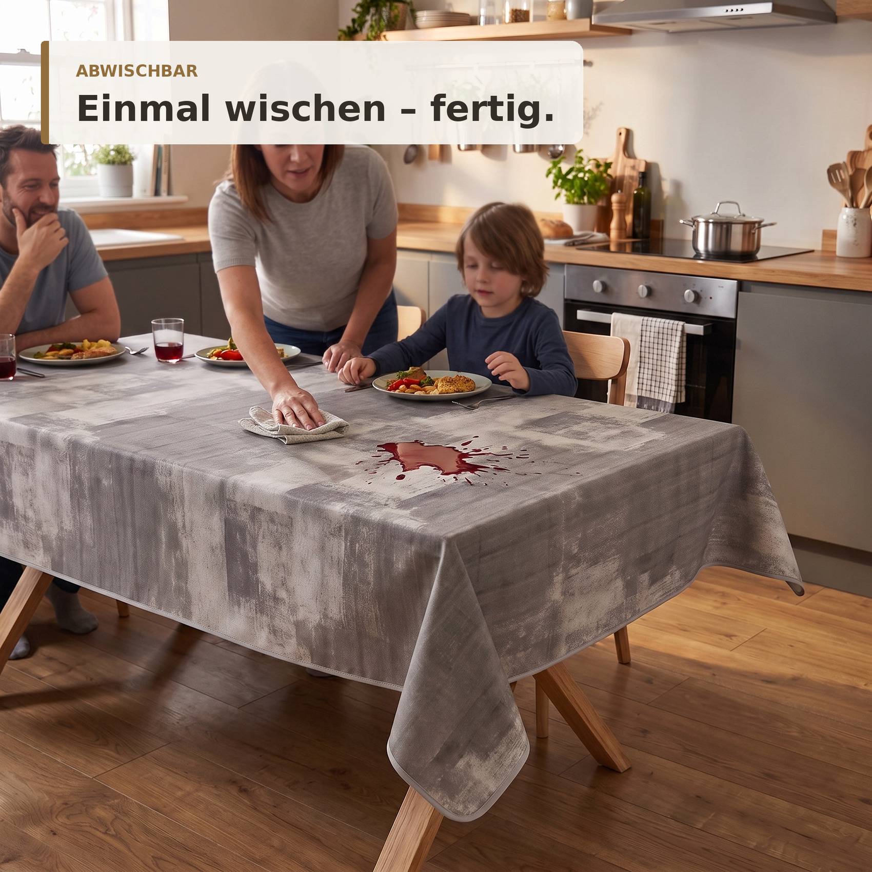 Familie räumt einen unordentlichen Küchentisch mit einem Einmaltuch auf; der Text sagt „ABWISCHBAR" und „Einmal wischen - fertig."