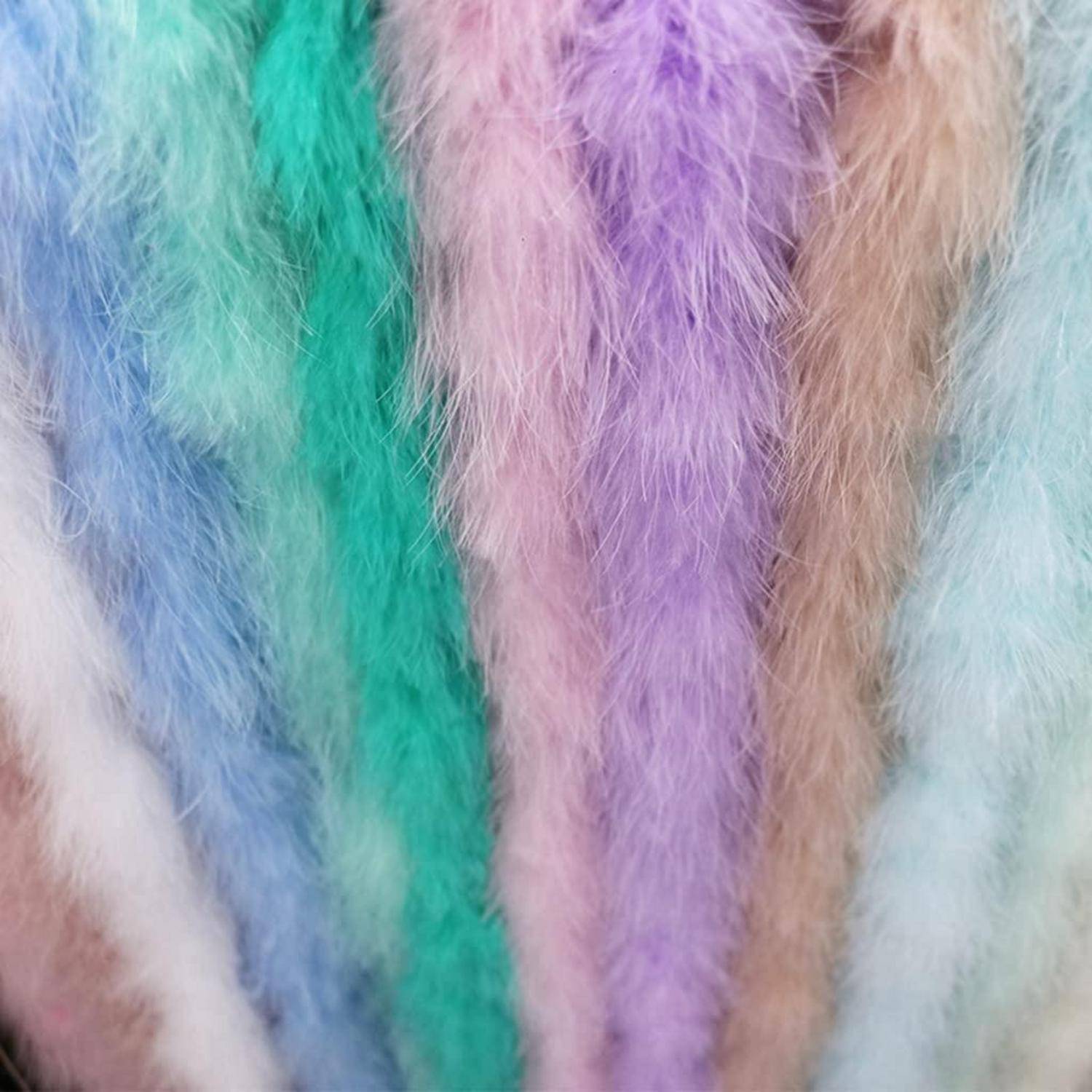 Nahaufnahme von weichen, mehrfarbigen Kunstfellstreifen in Pastellblau, Grün, Lila, Rosa, Beige und Weiß.