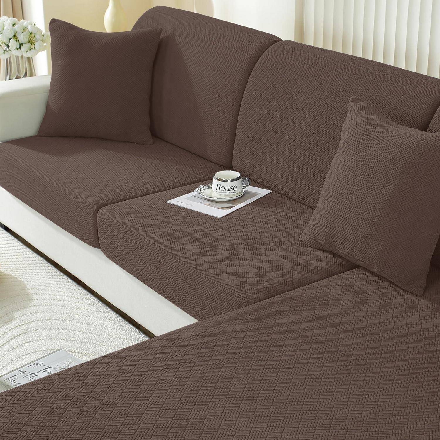 Braunes Ecksofa mit passenden Dekokissen; eine Tasse und eine Untertasse ruhen auf einem Magazin in einem hellen Wohnzimmer.