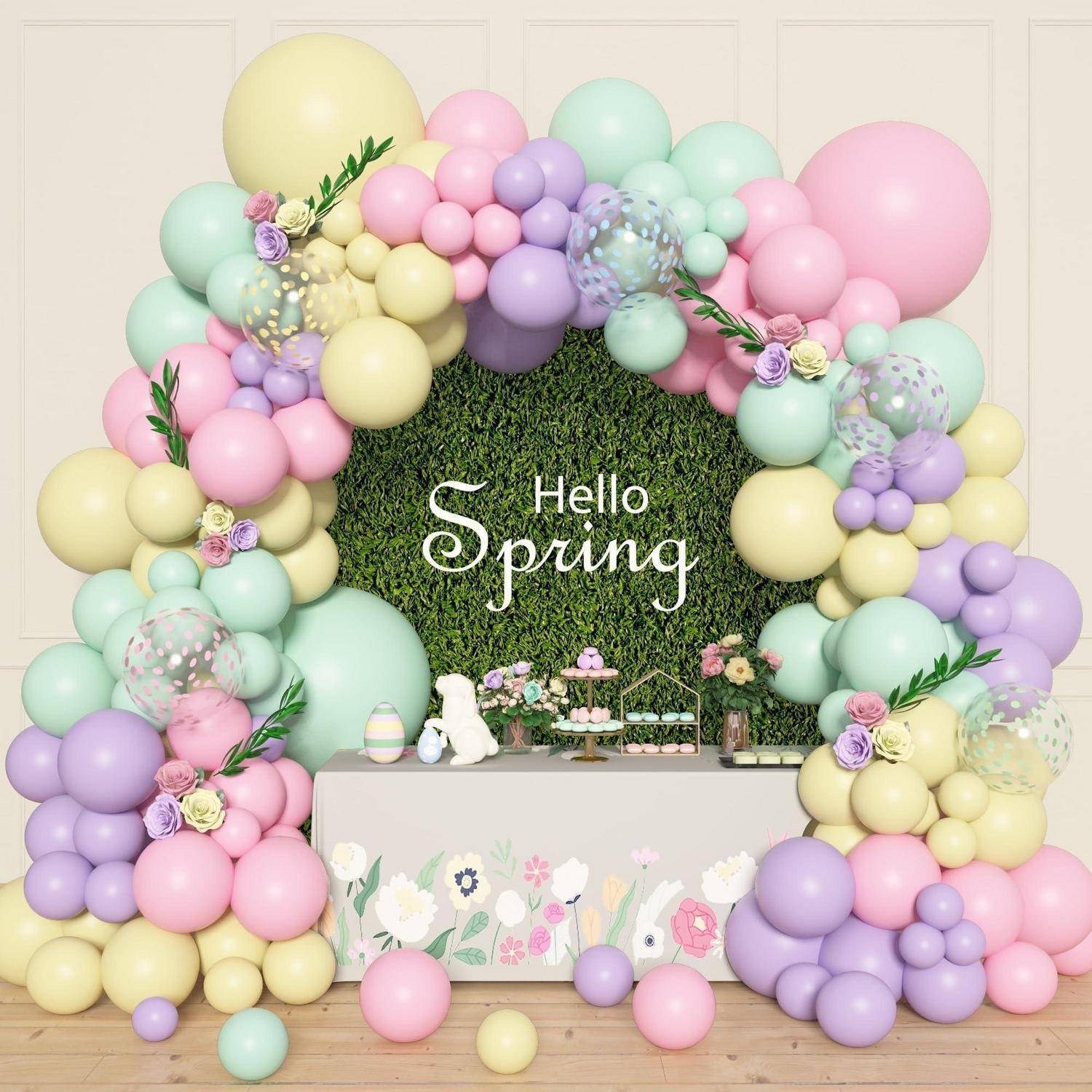 Frühjahrsfeier-Display mit pastellfarbener Ballongirlande um eine Grünwand mit der Aufschrift „Hello Spring