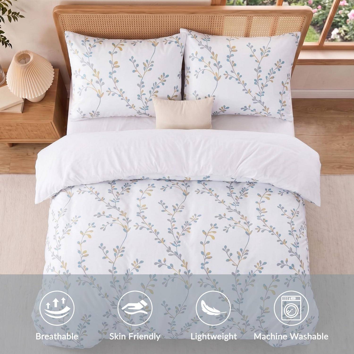 Bett mit weißer Blumenbettwäsche, Kissenbezügen und Bettdecke; Symbole heben atmungsaktiv, hautfreundlich, leicht und maschinenwaschbar hervor.