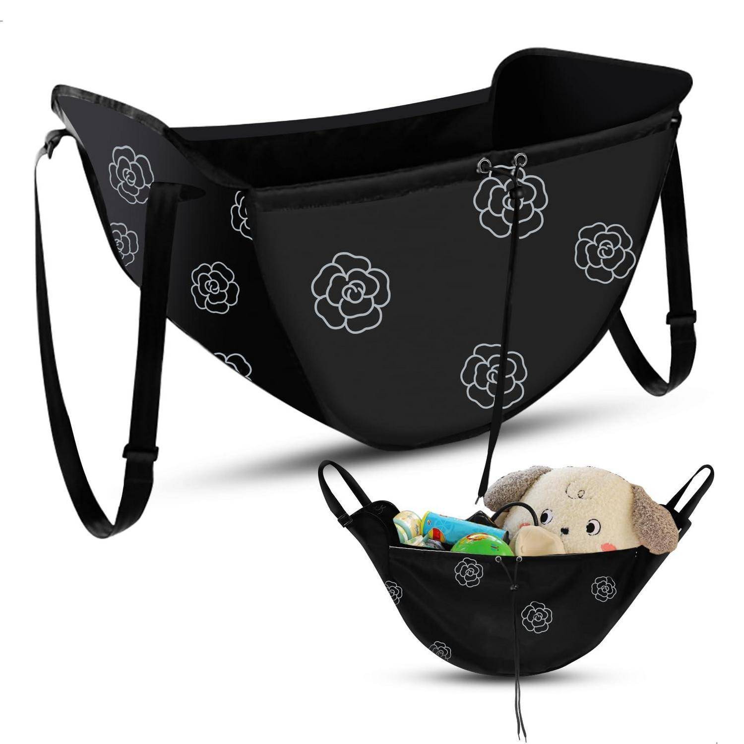 Schwarze Haustier-Tragetasche mit Blumenmuster und Schultergurten, leer gezeigt und mit einem kleinen Plüschhund für Größenvergleich gefüllt.
