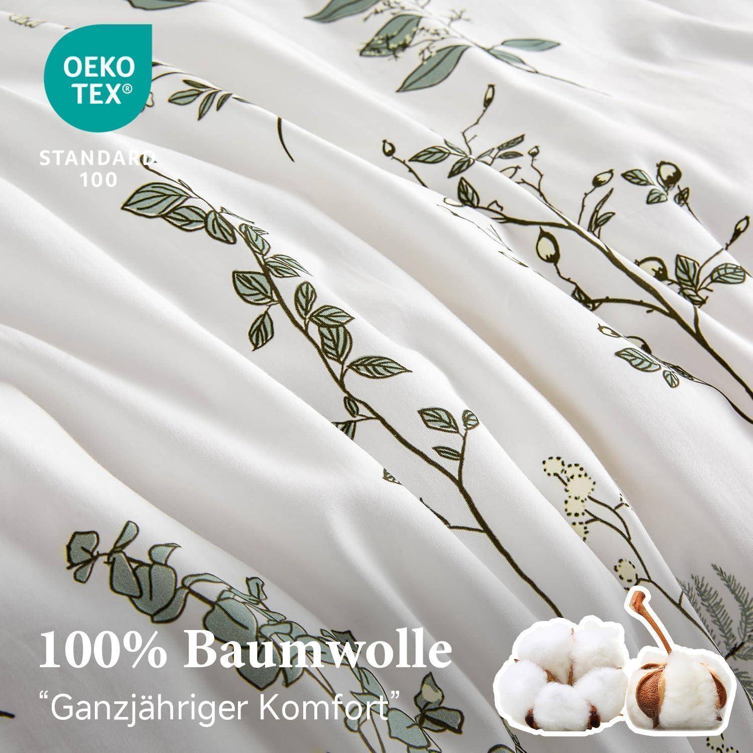 Weiße Baumwollbettwäsche mit grünem Rankenprint mit der Kennzeichnung „100% Baumwolle" und „Ganzjähriger Komfort"", plus OEKO-TEX STANDARD 100 Zertifizierungslogo.