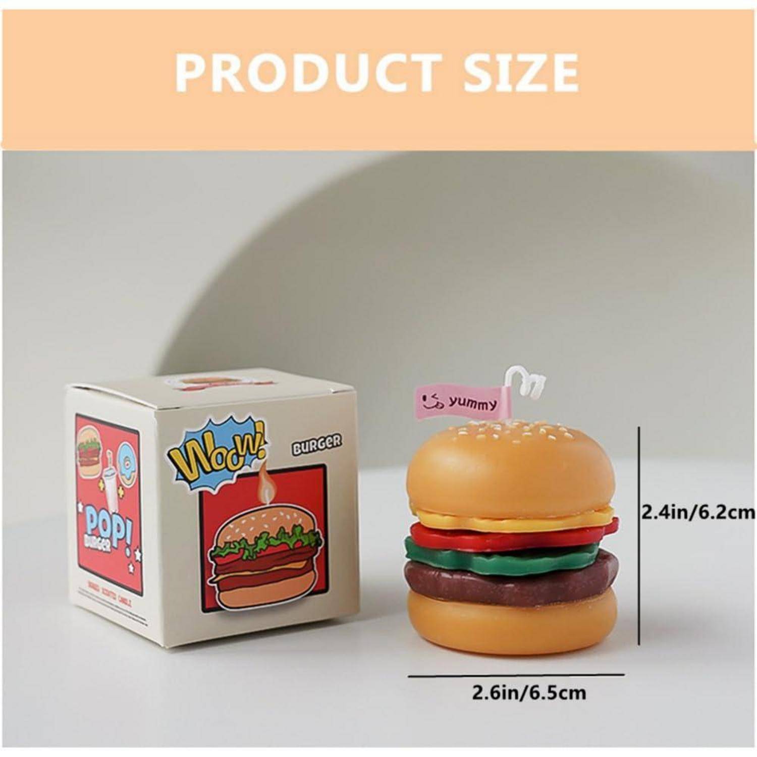 Produktgrößenbild mit einem Spielzeugburger und einer Schachtel; der Burger ist 2,6 Zoll/6,5 cm breit und 2,4 Zoll/6,2 cm groß.