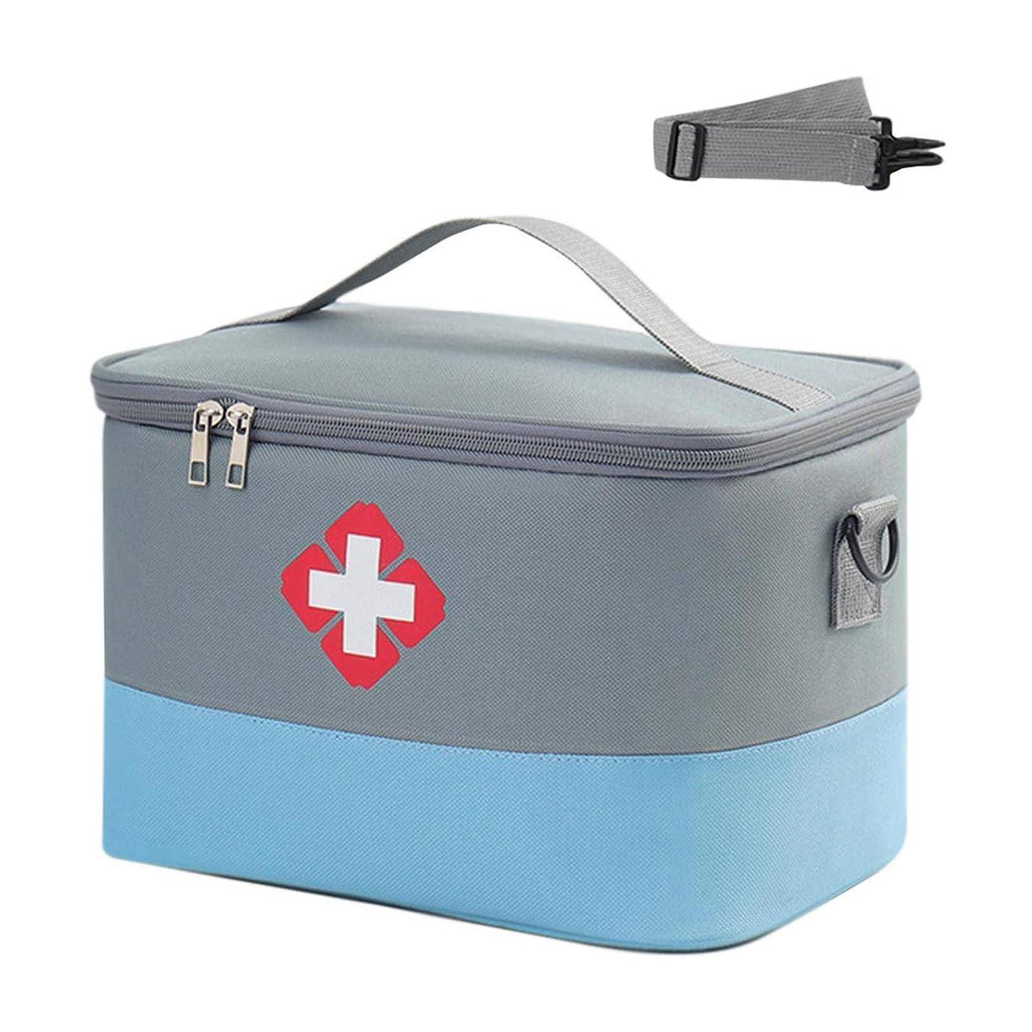 Grau-blaue isolierte medizinische Tasche mit weißem Kreuzemblem, Reißverschlusdeckel, Tragegriff und separat abgebildeter Schultergurtklammer.