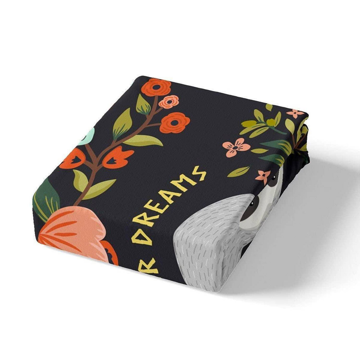 Schwarzes quadratisches Kissen mit Blumenmuster und einer Faultiér-Illustration, das das Wort „TRAUM