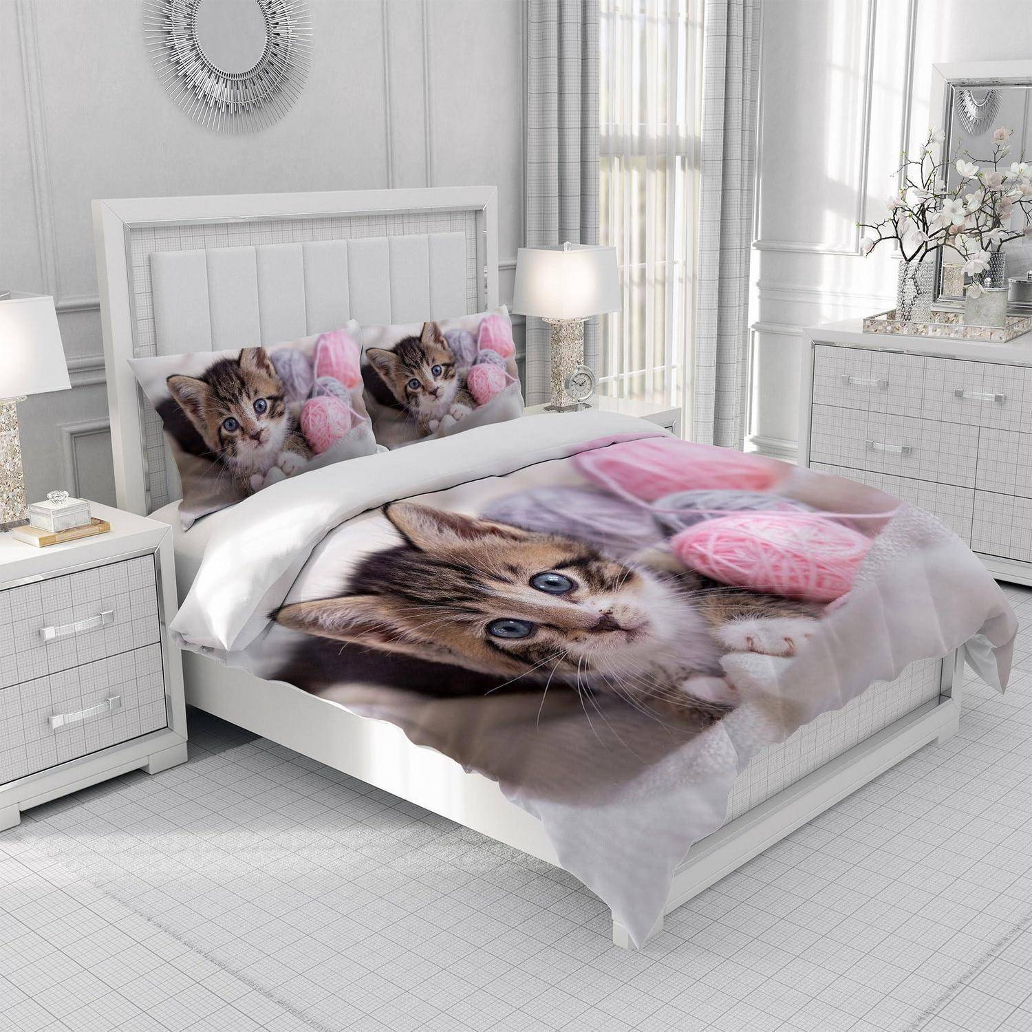 Weißes Schlafzimmer mit einem Bett, das mit Katzengesicht-Bettwäsche und Kissen bezogen ist, flankiert von Nachttischen und Lampen, in einem hellen, modernen Interieur.