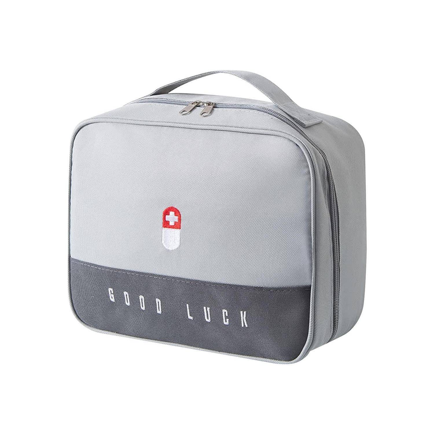 Graue isolierte Lunchbox mit Griff, rot-weißes medizinisches Symbol und Text „GOOD LUCK