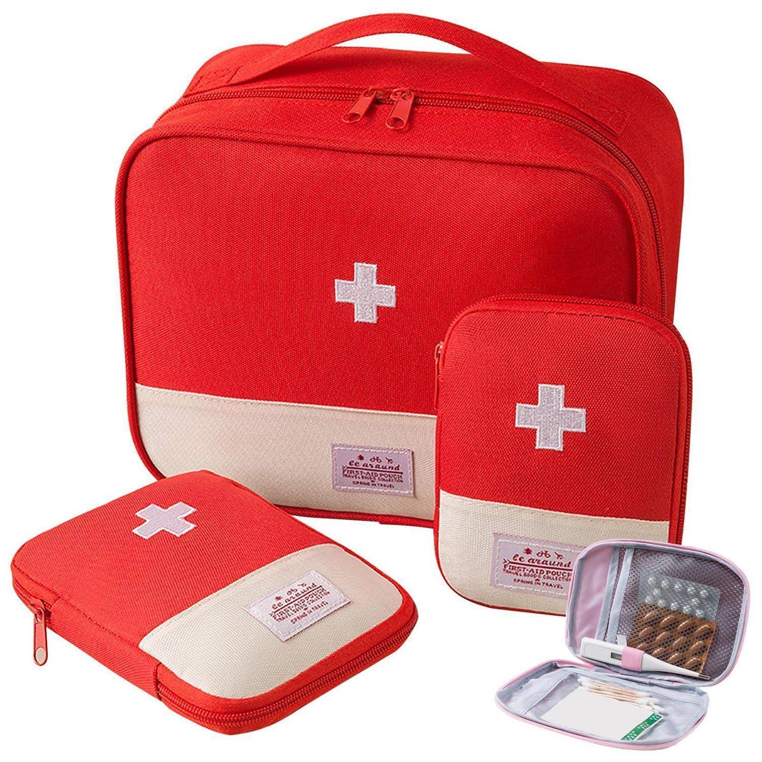 Rotes Erste-Hilfe-Set mit großem Reißverschluss-Koffer, kleineren Taschen und kompaktem Organizer, alle mit weißen Kreuzsymbolen gekennzeichnet.