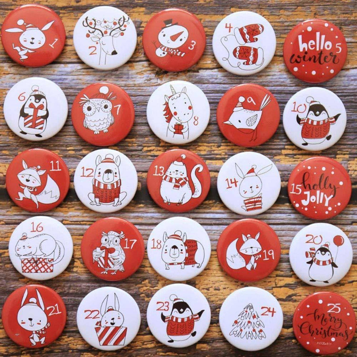 Assortierte rot-weiße weihnachtlich gestaltete nummerierte Knöpfe, 1 bis 25, mit Winterfiguren, Tieren und Weihnachtsgrüßen auf holzfarbenem Untergrund.