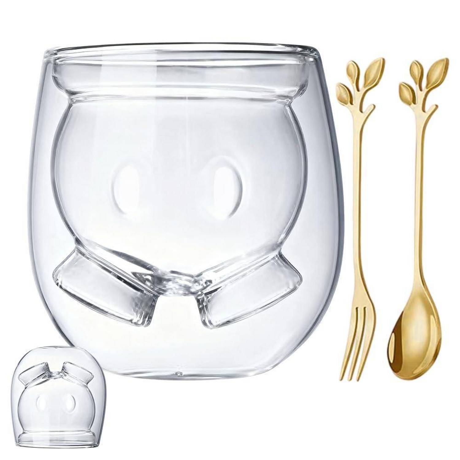 Klares doppelwandiges Glastasse mit Gesichtsdesign, gezeigt mit goldener Gabel und Löffel, plus eine kleine Einfügung der Tasse unten links.